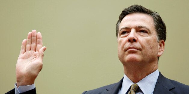 Director James Comey is sworn in before testifying at a House Oversight and Government Reform Committee on the