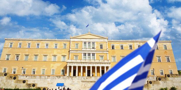 Athens, Greece - September 9, 2016: People walk around the Greece parliament on Syntagma square on summer sunny day in Athens.