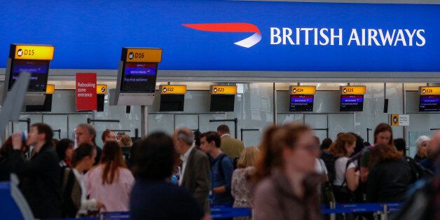 Passengers queue at check-in at the British Airways terminal, Terminal 5, at London Heathrow Airport, in London, U.K., on Tuesday, May 30, 2017. British Airways'epic meltdown over a busy holiday weekend further fanned public outrage of an industry infamous for its focus on cost cuts over customer service, leaving the U.K. carrier scrambling to explain how a local computer outage could lead to thousands of stranded passengers. Photographer: Luke MacGregor/Bloomberg via Getty Images