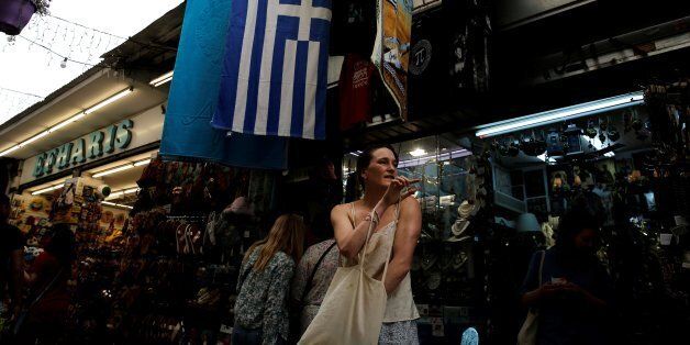 A woman exits a shop at the Monastiraki district in Athens, Greece, May 16, 2017. REUTERS/Costas Baltas
