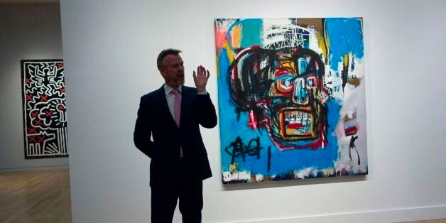 A Sotheby's official speaks about an untitled painting by Jean-Michel Basquiat during a media preview May 5, 2017 at Sotheby's In New York. The piece is one of the creations to be auctioned during the Impressionist and Modern Art evening sale May 16, 2017 in New York / AFP PHOTO / Don Emmert (Photo credit should read DON EMMERT/AFP/Getty Images)