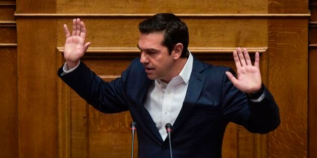 Greek Prime Minister Alexis Tsipras gestures as he delivers a speech during a parliamentary session in Athens on May 18, 2017. Greece's parliament was to approve a new round of austerity cuts, hoping to secure a pledge of debt relief and loan disbursements by the country's EU-IMF creditors this month. / AFP PHOTO / Angelos Tzortzinis (Photo credit should read ANGELOS TZORTZINIS/AFP/Getty Images)