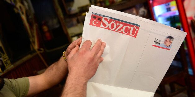 A man looks at blank pages of the latest edition of opposition daily newspaper Sozcu on May 20, 2017 in Istanbul. Turkish authorities targeted on May 19, 2017 opposition daily Sozcu, seeking the arrest of the owner and detaining two employees as the crackdown on opposition media widened. / AFP PHOTO / YASIN AKGUL (Photo credit should read YASIN AKGUL/AFP/Getty Images)