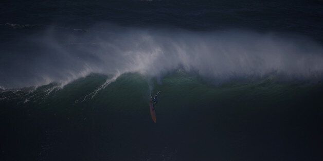 Big-wave surfer Trevor Carlson of Hawaii drops in on a large wave during the Nazare Challenge championship at Praia do Norte in Nazare, Portugal December 20, 2016. REUTERS/Rafael Marchante