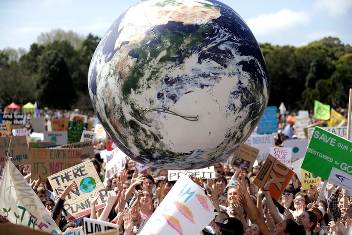 A large inflatable globe is bounced through the crowd as thousands of protestors, many of them students, gather in Sydney, Friday, Sept. 20, 2019. (AP Photo/Rick Rycroft)