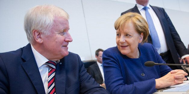 German Chancellor Angela Merkel (R), leader of the conservative Christian Democratic Union (CDU), and Horst Seehofer, leader of the CDU's Bavarian ally, the Christian Social Union (CSU), have taken seat for a meeting with the CDU/CSU parlamentary group in Berlin on September 26, 2017 in Berlin, two days after general elections. / AFP PHOTO / Steffi LOOS (Photo credit should read STEFFI LOOS/AFP/Getty Images)