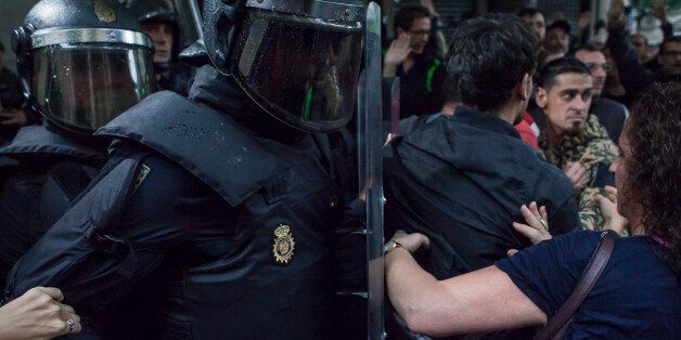 BARCELONA, CATALUNYA, SPAIN - 2017/10/01: People clash with the Spanish police 'Policia Nacional' after they closed down a polling station. Today the referendum was held to vote for the independence of Catalunya region. (Photo by Andrea Baldo/LightRocket via Getty Images)