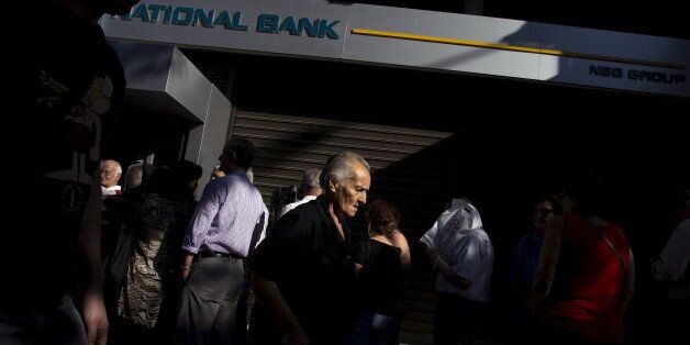 People queue to receive their pensions in front of a National Bank in Athens, Greece, July 2, 2015. Long lines of pensioners jostling to get into a limited number of banks opened specially to pay out retirement benefits have become a powerful symbol of the misery facing Greece and the problems mounting for Prime Minister Alexis Tsipras. REUTERS/Marko Djurica