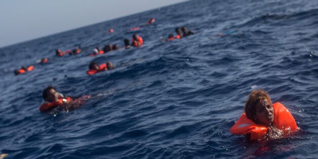 LAMPEDUSA, ITALY - MAY 24: Refugees and migrants are seen swimming and yelling for assistance from crew members from the Migrant Offshore Aid Station (MOAS) 'Phoenix' vessel after a wooden boat bound for Italy carrying more than 500 people capsized on May 24, 2017 off Lampedusa, Italy. Numbers of refugees and migrants attempting the dangerous central Mediterranean crossing from Libya to Italy has risen since the same time last year with more than 43,000 people recorded so far in 2017. In an attempt to slow the flow of migrants Italy recently signed a deal with Libya, Chad and Niger outlining a plan to increase border controls and add new reception centers in the African nations, which are key transit points for migrants heading to Italy. MOAS is a Malta based NGO dedicated to providing professional search-and-rescue assistance to refugees and migrants in distress at sea. Since the start of the year MOAS have rescued and assisted 3572 people and are currently patrolling and running rescue operations in international waters off the coast of Libya. (Photo by Chris McGrath/Getty Images)