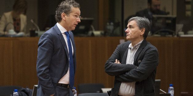 Jeroen Dijsselbloem, Dutch finance minister and head of the group of euro-area finance ministers, left, speaks with Euclid Tsakalotos, Greece's finance minister, ahead of an Ecofin meeting of European Union (EU) finance ministers in Brussels, Belgium, on Tuesday, Dec. 6, 2016. The euro-area economy expanded at the fastest pace this year in November as companies took on workers and kept political concerns at bay. Photographer: Jasper Juinen/Bloomberg via Getty Images