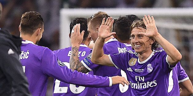 Real Madrid's Croatian midfielder Luka Modric (R) celebrates after winning the UEFA Champions League final football match between Juventus and Real Madrid at The Principality Stadium in Cardiff, south Wales, on June 3, 2017. / AFP PHOTO / Filippo MONTEFORTE (Photo credit should read FILIPPO MONTEFORTE/AFP/Getty Images)