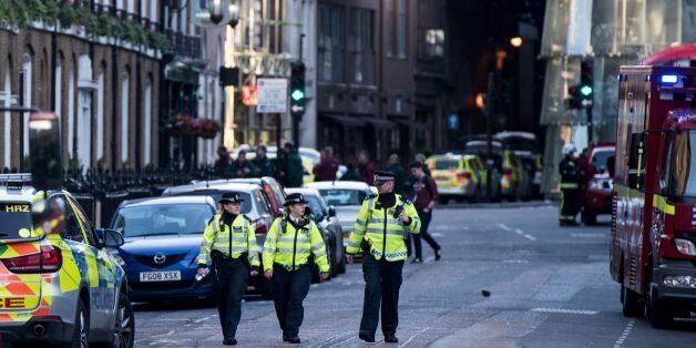 Police officers and emergency response vehicles are seen on the street outside Borough Market on June 04, 2017 the morning after a terror attack on London Bridge and the Borough area in London. Six people have been reportedly killed and three terror suspects shot dead by police following the attack on the evening on June 03, 2017. / AFP PHOTO / CHRIS J RATCLIFFE (Photo credit should read CHRIS J RATCLIFFE/AFP/Getty Images)