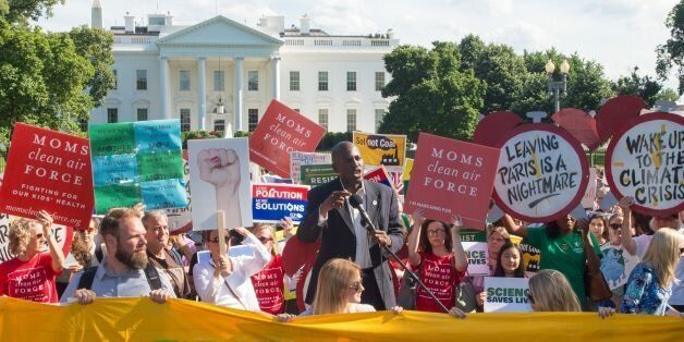 Protesters hold up signs during a demonstration in front of the White House in Washington, DC on June 1, 2017, objecting to US President Donald Trump's decision to withdraw from the Paris Climate accord.President Donald Trump declared that the United States will withdraw from the 2015 Paris accord and try to negotiate a new global deal on climate change. / AFP PHOTO / PAUL J. RICHARDS (Photo credit should read PAUL J. RICHARDS/AFP/Getty Images)