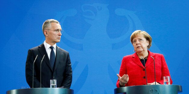 NATO Secretary-General Jens Stoltenberg and German Chancellor Angela Merkel address a news conference following their talks in Berlin, Germany, May 11, 2017. REUTERS/Fabrizio Bensch