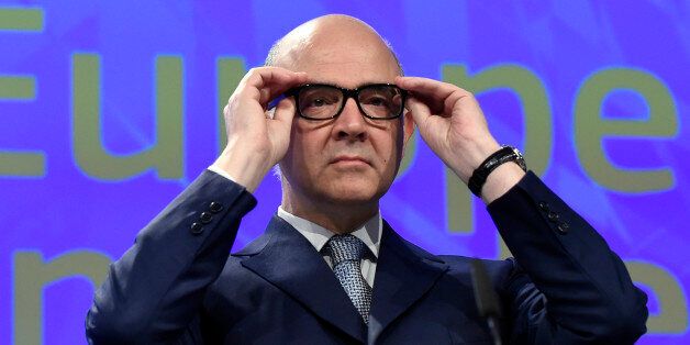 EU Commissioner of Economic and Financial Affairs, Taxation and Customs Pierre Moscovici puts his glasses on before delivering a speech during a joint press conference regarding European semester package on country specific recommendations, at the EU headquarters, in Brussels on May 22, 2017. / AFP PHOTO / JOHN THYS (Photo credit should read JOHN THYS/AFP/Getty Images)