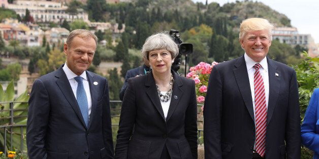 TAORMINA, ITALY - MAY 26: G7 leaders European Council President Donald Tusk, British Prime Minister Theresa May and U.S. President Donald Trump attend a flypast at San Domenico Palace Hotel on May 26, 2017 in Taormina , Italy. US President Donald Trump and British Prime Minister Theresa May attend a G7 summit for the first time since their elections. Also new to the table is French President Emmanuel Macron. China have been invited to a meeting during the summit for the first time. (Photo by Dan Kitwood/Getty Images)