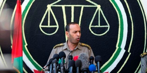 Head of the Military court, Nasser Suleiman, speaks to the press in Gaza City on May 21, 2017.A court in the Gaza Strip sentenced three men to death over the assassination of a Hamas military commander that the Islamist movement accused Israel of masterminding. / AFP PHOTO / MAHMUD HAMS (Photo credit should read MAHMUD HAMS/AFP/Getty Images)
