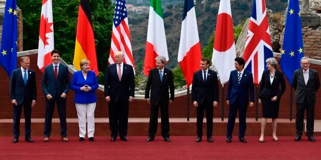 From left : President of the European Council Donald Tusk, Canadian Prime Minister Justin Trudeau, German Chancellor Angela Merkel, US President Donald Trump, Italian Prime Minister Paolo Gentiloni, French President Emmanuel Macron, Japanese Prime Minister Shinzo Abe, Britain's Prime Minister Theresa May and President of the European Commission Jean-Claude Juncker pose for a family photo at the ancient Greek Theatre of Taormina during the Heads of State and of Government G7 summit, on May 26, 2017 in Sicily.The leaders of Britain, Canada, France, Germany, Japan, the US and Italy will be joined by representatives of the European Union and the International Monetary Fund (IMF) as well as teams from Ethiopia, Kenya, Niger, Nigeria and Tunisia during the summit from May 26 to 27, 2017. / AFP PHOTO / Miguel MEDINA (Photo credit should read MIGUEL MEDINA/AFP/Getty Images)