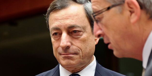 Mario Draghi, president of the European Central Bank, left, speaks with Jean-Claude Juncker, Luxembourg's prime minister and president of the Eurogroup, during the meeting of Eurogroup finance ministers at the European Council headquarters in Brussels, Belgium, on Monday, Nov. 7, 2011. Juncker said he expects Greece's new government quickly to affirm its commitment to implementing the terms of a second international bailout. Photographer: Jock Fistick/Bloomberg via Getty Images