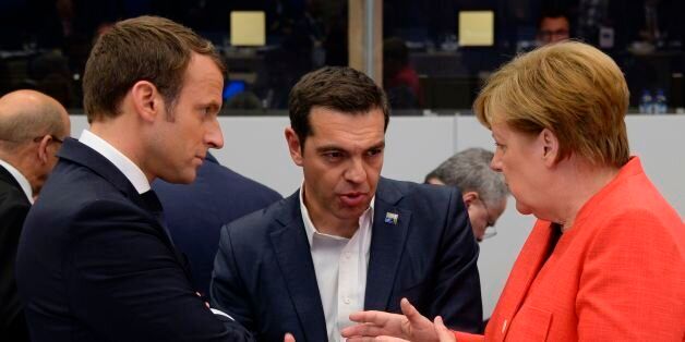 German Chancellor Angela Merkel (R) and Greek Prime Minister Alexis Tsipras (C) gesture as they speak with French President Emmanuel Macron (L) during the NATO (North Atlantic Treaty Organization) summit at the NATO headquarters, in Brussels, on May 25, 2017. / AFP PHOTO / POOL / THIERRY CHARLIER (Photo credit should read THIERRY CHARLIER/AFP/Getty Images)