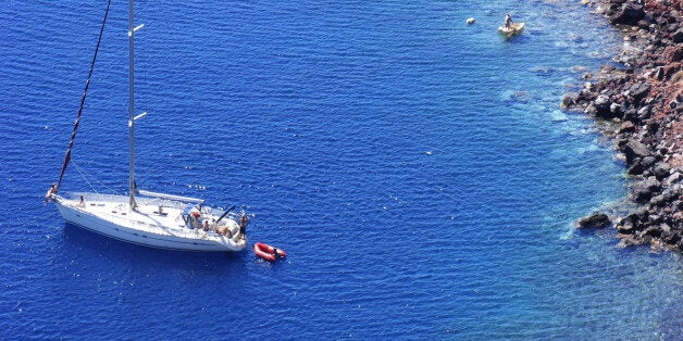 (AUSTRALIA & NEW ZEALAND OUT) Yacht anchored in the clear waters off Oia in Santorini, Greece. AFR Picture by LOUIE DOUVIS (Photo by Fairfax Media via Getty Images)