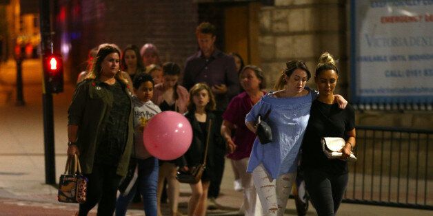 MANCHESTER, ENGLAND - MAY 23: Members of the public are escorted from the Manchester Arena on May 23, 2017 in Manchester, England. An explosion occurred at Manchester Arena as concert goers were leaving the venue after Ariana Grande had performed. Greater Manchester Police have confirmed 19 fatalities and at least 50 injured. (Photo by Dave Thompson/Getty Images)
