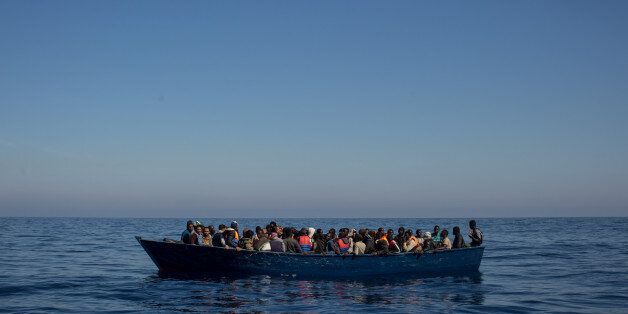 LAMPEDUSA, ITALY - MAY 18: Refugees and migrants wait to be rescued from an overcrowded boat by crew members from the Migrant Offshore Aid Station (MOAS) Phoenix vessel on May 18, 2017 off Lampedusa, Italy. Numbers of refugees and migrants attempting the dangerous central Mediterranean crossing from Libya to Italy has risen since the same time last year with more than 43,000 people recorded so far in 2017. MOAS is a Malta based NGO dedicated to providing professional search-and-rescue assistance to refugees and migrants in distress at sea. Since the start of the year MOAS have rescued and assisted 3214 people and are currently patrolling and running rescue operations in international waters off the coast of Libya. (Photo by Chris McGrath/Getty Images)
