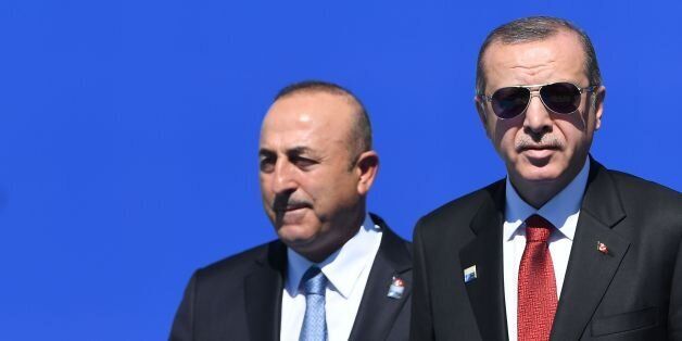 Turkish President Recep Tayyip Erdogan (R), flanked by Turkish Minister for Foreign Affairs Mevlut Cavusoglu (L), arrives for the NATO (North Atlantic Treaty Organization) summit at the NATO headquarters, in Brussels, on May 25, 2017. / AFP PHOTO / Emmanuel DUNAND (Photo credit should read EMMANUEL DUNAND/AFP/Getty Images)