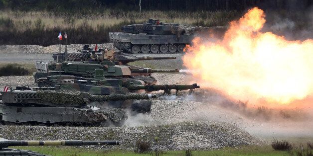 Tanks of several nations shoot at the same time during the friendship shooting of the exercise 'Strong Europe Tank Challenge 2017' at the exercise area in Grafenwoehr, near Eschenbach, southern Germany, on May 12, 2017.Platoons from NATO nations France, Germany, USA and their partners Austria and Ukraine take part in this exercise. / AFP PHOTO / Christof STACHE (Photo credit should read CHRISTOF STACHE/AFP/Getty Images)