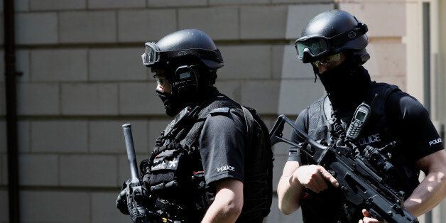 Armed police officers stand outside a residential property near to where a man was arrested in the Chorlton area of Manchester, Britain May 23, 2017. REUTERS/Stefan Wermuth