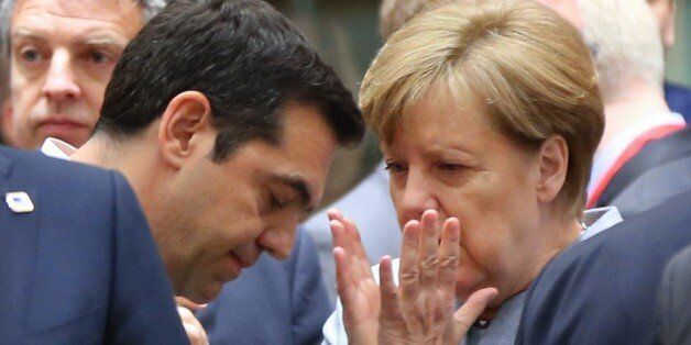 BRUSSELS, BELGIUM - APRIL 29 : German Chancellor Angela Merkel (R) and Greek Prime Minister Alexis Tsipras (L) speak together during a special EU Leaders' meeting of the European Council to adopt the guidelines for the Brexit talks, in Brussels, Belgium on April 29, 2017. (Photo by Dursun Aydemir/Anadolu Agency/Getty Images)