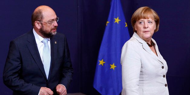 European Parliament President Martin Schulz (L) and Germany's Chancellor Angela Merkel (R) take part in a group photo during a EU summit in Brussels June 27, 2013. European officials struck two significant deals on banking resolution and their long-term budget in last-ditch negotiations early on Thursday, giving EU leaders a much needed lift before a summit on youth unemployment and growth. REUTERS/Yves Herman (BELGIUM - Tags: POLITICS BUSINESS EMPLOYMENT)