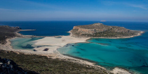 One of the most visited beaches in Greece, Balos. It is located in the western part of the island in the perfecture of Chania and is about one hour driving from Chania. Balos is the most iconic beach in Crete and attracts thousands of tourists every day as it seems like an exotic beach. The place is protected. There are shallow and warm waters, sand dunes in the sandy beach and the water is crystal clear with turqoise color. There is also the pirate island called Gramvousa. People can go to Balos either by walking about 20 min on the rocky path or by boat. (Photo by Nicolas Economou/NurPhoto via Getty Images)