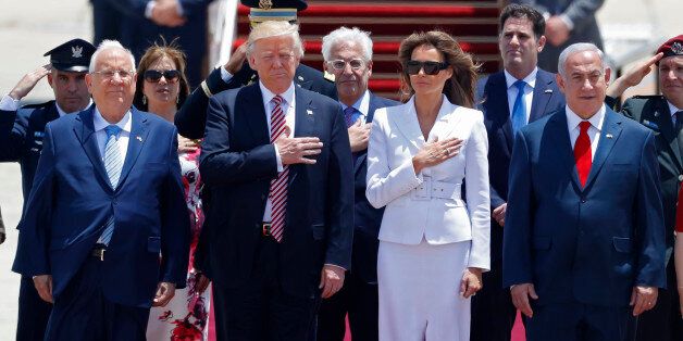 US President Donald Trump (C-L) and First Lady Melania Trump (C-R) listen to the their national anthem as they are welcomed by Israeli Prime Minister Benjamin Netanyahu (R), and Israeli President Reuven Rivlin (L) upon their arrival at Ben Gurion International Airport in Tel Aviv on May 22, 2017, as part of his first trip overseas. / AFP PHOTO / Jack GUEZ (Photo credit should read JACK GUEZ/AFP/Getty Images)