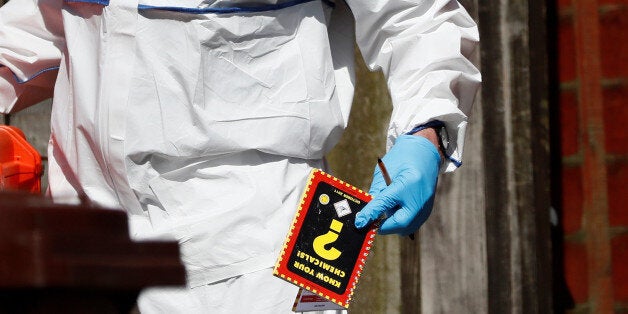 A police investigator holds a chemistry notebook as he works at residential property in south Manchester, Britain May 23, 2017. REUTERS/Stefan Wermuth