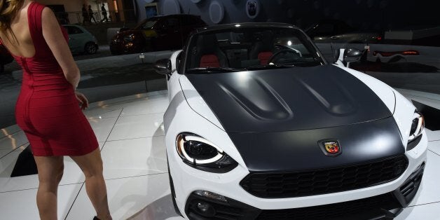 A model stands next to the Fiat 124 Spider during the New York International Auto Show at the Javits center in New York on April 13, 2017. / AFP PHOTO / TIMOTHY A. CLARY (Photo credit should read TIMOTHY A. CLARY/AFP/Getty Images)