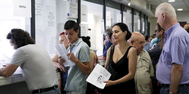People line up inside a tax office in Athens, Greece, June 25, 2015. Monthly reports by Greece's financial crimes units highlight just how common tax dodging is, from doctors to farmers to contractors and civil servants. That, and the prevalence of small- and medium-sized businesses and the self-employed, as well as the sizeable shadow economy, shows just how difficult it is to crack down on Greece's corruption and tax evasion, which leftist Prime Minister Alexis Tsipras has made one of his priorities. To match Insight EUROZONE-GREECE/TAXES REUTERS/Alkis Konstantinidis