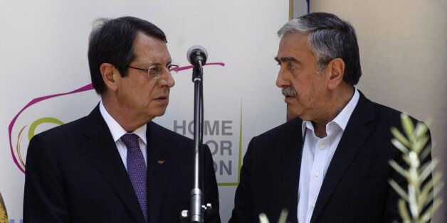 Greek Cypriot President Nicos Anastasiades (L) and Turkish Cypriot leader Mustafa Akinci (R) talk during a social function in Nicosias UN-patrolled buffer zone on June 2, 2016. Cypriot leaders agreed in the meeting to resume their stalled peace talks on June 8 after President Nicos Anastasiades had suspended the UN-brokered negotiations. Talks were shelved after Anastasiades snubbed a dinner held for state leaders at a UN-organised humanitarian summit in Istanbul when he found out that Akinci was also invited. / AFP / Iakovos Hatzistavrou (Photo credit should read IAKOVOS HATZISTAVROU/AFP/Getty Images)