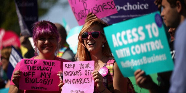 WASHINGTON, DC - JUNE 30: Supporters of employer-paid birth control rally in front of the Supreme Court before the decision in Burwell v. Hobby Lobby Stores was announced June 30, 2014 in Washington, DC. The high court ruled 5-4 that requiring family-owned corporations to pay for insurance coverage for contraception under the Affordable Care Act violated a federal law protecting religious freedom. (Photo by Chip Somodevilla/Getty Images)