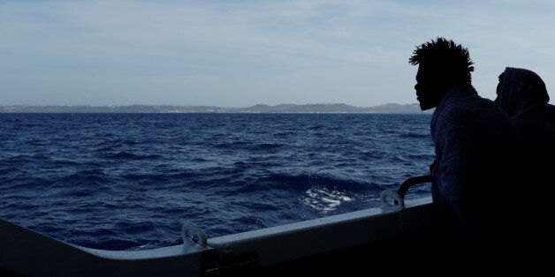 Migrants look out towards the Maltese island of Gozo as the Malta-based NGO Migrant Offshore Aid Station (MOAS) ship Phoenix makes its way towards Italy after rescue operations off the coast of Libya, May 5, 2017. REUTERS/Darrin Zammit Lupi