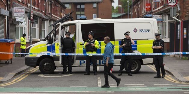 Police officers stand guard on Banff Road in the Rusholme area of Manchester, in north west England on May 29, 2017, as they continue their investigations in the wake of the May 22 Manchester Arena bomb attack.A total of 16 people are in detention in Britain and Libya over the May 22 suicide bombing at an Ariane Grande pop concert in the English city of Manchester by a British-born man of Libyan origin. / AFP PHOTO / JON SUPER (Photo credit should read JON SUPER/AFP/Getty Images)
