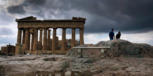 The temple of the Parthenon is reflected in a rain puddle atop the ancient hill of the Acropolis during a rainy day October 24, 2012. After a long a hot summer, cooler temperatures and showers this week marked the beginning of the autumn season in Greece. REUTERS/Yannis Behrakis (GREECE - Tags: ENVIRONMENT)