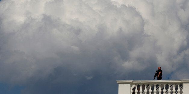 A Secret Service counter-assault team member keeps watch from the roof of the White House during a potential security threat on the North Lawn in Washington, U.S. May 31, 2017. REUTERS/Jonathan Ernst