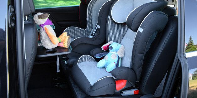 Side shot on the seats for children mounted in minivan.