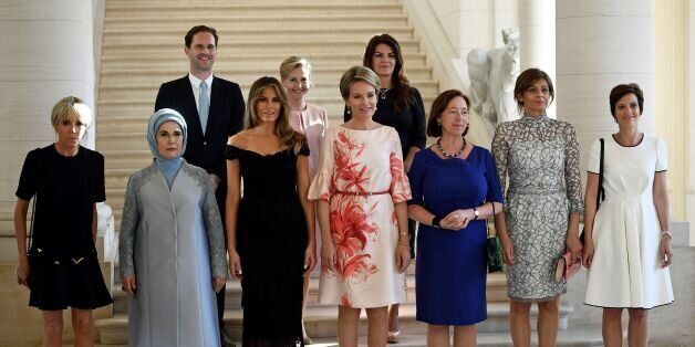 (Front row LtoR) Brigitte Macron, wife of French President, Emine Gulbaran Erdogan, wife of Turkey's President, First Lady of the US Melania Trump, Queen Mathilde of Belgium, Stoltenberg's wife Ingrid Schulerud, partner of Bulgaria's President Desislava Radeva, partner of Charles Michel Amelie Derbaudrenghien, (back row, LtoR), husband of Luxembourg's prime minister Gauthier Destenay, partner of Slovenia's Prime Minister Mojca Stropnik and wife of Iceland's President Thora Margret Baldvinsdottir pose for a family photo before a diner at the Royal castle in Laken/Laeken, on May 25, 2017, in Brussels. / AFP PHOTO / BELGA / YORICK JANSENS / Belgium OUT (Photo credit should read YORICK JANSENS/AFP/Getty Images)