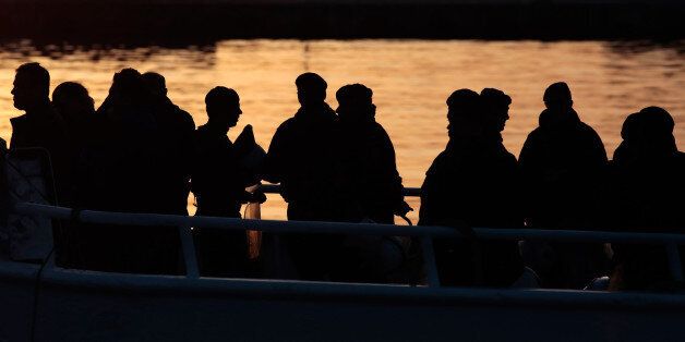 MYTILENE, GREECE - APRIL 4: Frontex police escort migrants, who are being deported from Lesbos, on to a ferry before it returns to Turkey on April 4, 2016 in Lesbos, Greece. Scores migrants are being returned to Turkey following an EU agreement with the Turkish authorities to tackle Europe's worsening mass migration crisis. Migrants who have arrived illegally in Greece are now being deported back to Turkey if they refuse to apply for asylum. (Photo by Milos Bicanski/Getty Images)