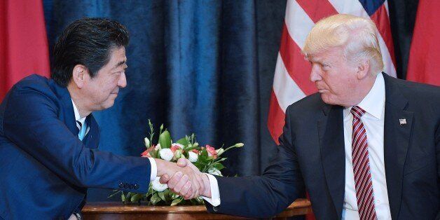 TOPSHOT - US President Donald Trump (R) shakes hands with Japanese Prime Minister Shinzo Abe during a bilateral meeting at the Villa Diodoro on the sidelines of the Summit of the Heads of State and of Government of the G7, the group of most industrialized economies, plus the European Union, on May 26, 2017 in Taormina, Sicily.The leaders of Britain, Canada, France, Germany, Japan, the US and Italy will be joined by representatives of the European Union and the International Monetary Fund (IMF) as well as teams from Ethiopia, Kenya, Niger, Nigeria and Tunisia during the summit from May 26 to 27, 2017. / AFP PHOTO / MANDEL NGAN (Photo credit should read MANDEL NGAN/AFP/Getty Images)