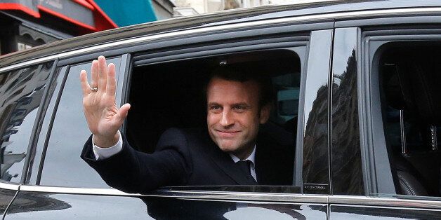 Emmanuel Macron, head of the political movement En Marche !, or Onwards !, and candidate for the 2017 presidential election, waves from his car as he leaves his home during the second round of the election, in Paris, France, May 7, 2017. REUTERS/Jean-Paul Pelissier TPX IMAGES OF THE DAY