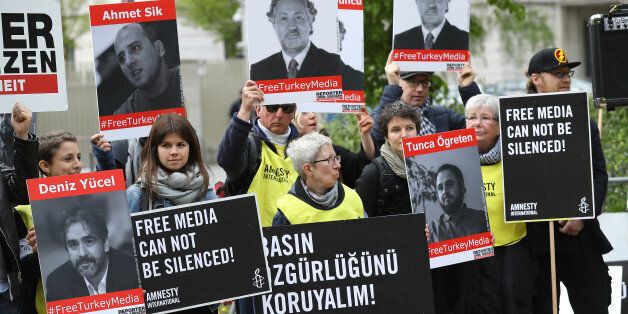 BERLIN, GERMANY - MAY 03: Activists, including supporters of Reporters Without Borders and Amnesty International, hold up the photos of journalists who are currently in prison in Turkey while protesting on World Press Freedom Day in front of the Turkish Embassy on May 3, 2017 in Berlin, Germany. Turkey has imprisoned over 150 journalists as part of the government's crackdown on independent media and political opposition. (Photo by Sean Gallup/Getty Images)
