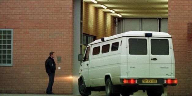 A police van blocks the side entrance of the Scheveningen detention center December 18 shortly after an ambulance arrived carrying injured Bosnian Croat war crimes suspect Vlatko Kupreskic. Kupreskic was injured during an exchange of fire during his arrest together with Anto Furendzija by the NATO-led peace force in Bosnia early this morning. Kupreskic and Furendzija are both accused of participating in a massacre in April 1993 in the village of Ahmici in which 103 Moslem civilians, including 33